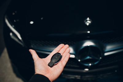 High angle view of person hand holding car