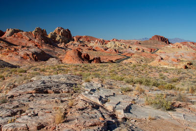 Scenic view of rocky mountains against blue sky