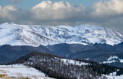 Scenic view of snowcapped mountains against sky