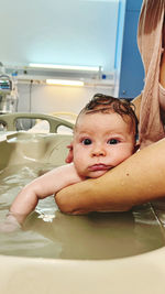 High angle view of cute baby boy lying on table