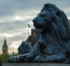 Statue of lion against sky during sunset