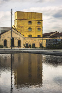 Reflection of building in lake at sunset