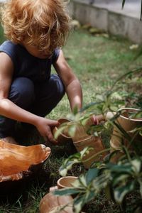 High angle view of boy standing amidst plants