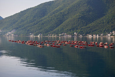 Boats moored in lake against mountains