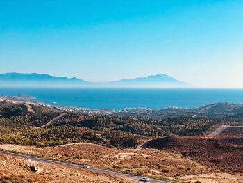 Scenic view of landscape against clear blue sky.