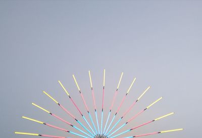 Low angle view of multi colored pencils against clear sky