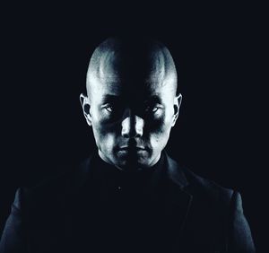 Low-key portrait of man against black background