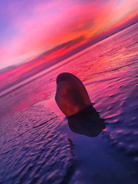 Close-up of sea against orange sky