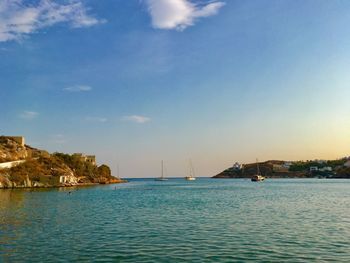 Sailboats in sea against sky