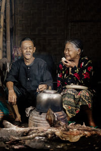 Portrait of senior man preparing food on barbecue grill