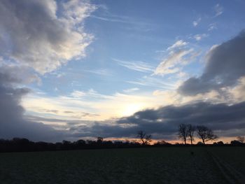 Scenic view of landscape against sky at sunset