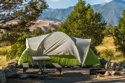 Scenic view campground pitch with large green tent. camping in great sand dunes national park