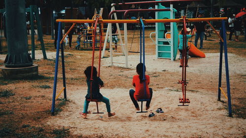Rear view of girls enjoying in playground