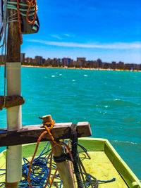 View of boat in sea against blue sky