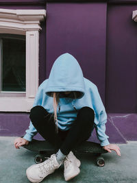 Full length of woman sitting outdoors