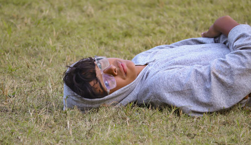 Low section of woman lying on grass