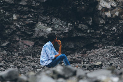 Man sitting on rock