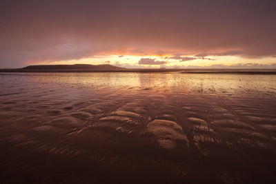 Scenic view of sea against romantic sky at sunset
