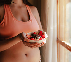 Midsection of woman holding ice cream