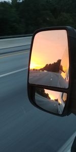 Reflection of car on side-view mirror