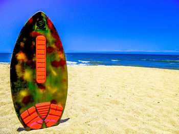 Scenic view of beach against blue sky