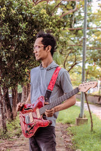 Full length of man playing guitar