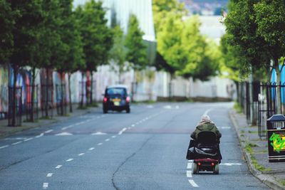 Rear view of woman walking on street