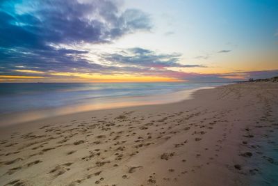 Scenic view of beach at sunset