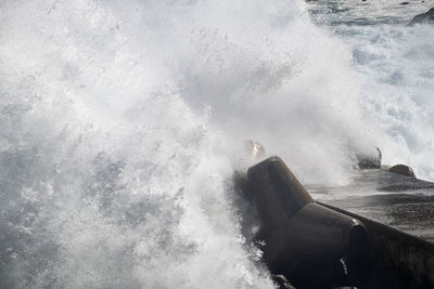 High angle view of waves splashing on sea