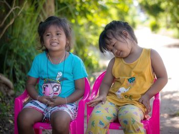Portrait of smiling girl sitting outdoors