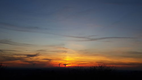 Scenic view of silhouette landscape against romantic sky at sunset