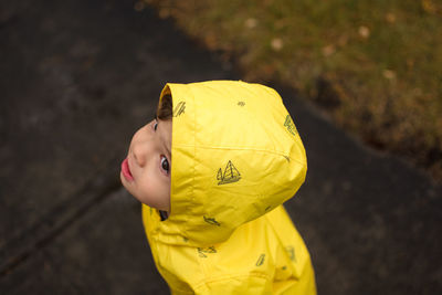 Boy holding yellow umbrella