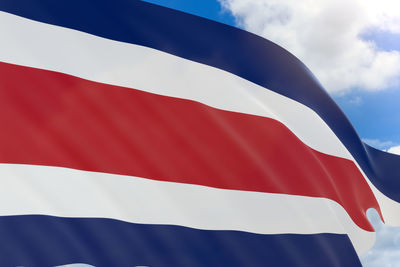 Low angle view of flag against blue sky