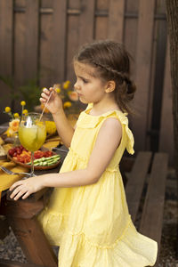 Portrait of cute girl eating food at home