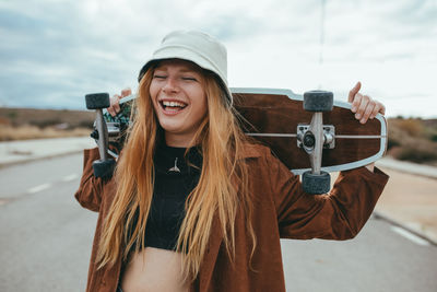 Portrait of smiling young woman standing outdoors