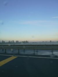 Road in city against clear sky