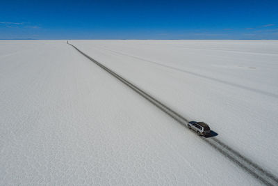 Car crossing the sal flat from aerial view