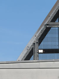 Low angle view of modern building against clear blue sky