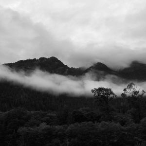 Scenic view of mountains against cloudy sky