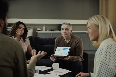 Group of business people having meeting in lobby