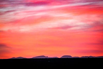 Scenic view of silhouette mountain against sky during sunset