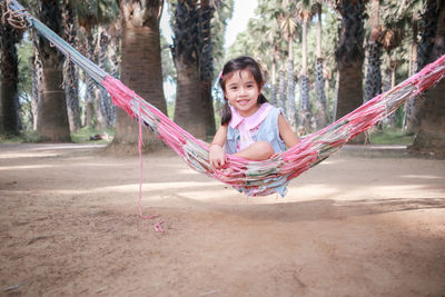 Portrait of girl sitting on hammock