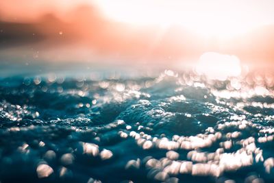 Close-up of snow against sky during sunset