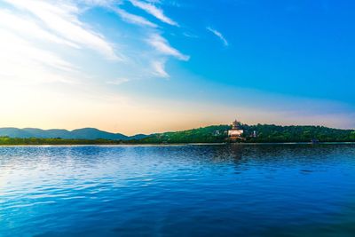 Scenic view of lake against cloudy sky