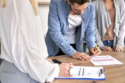 Man signing documents on table