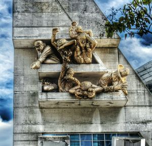 Low angle view of statue against building