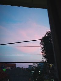 Low angle view of silhouette buildings against sky at sunset