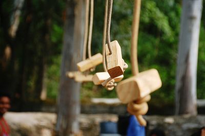 Close-up of wooden decorations hanging outdoors