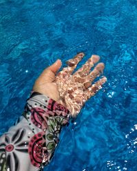 Low section of woman swimming in pool