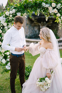 Cheerful newlywed couple standing outdoors